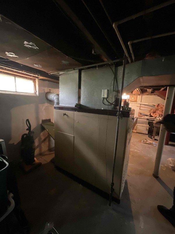 Provided comprehensive estimate for replacement of 50-year-old natural gas furnace and air conditioning system currently located in basement. Both units are operational but have reached end of serviceable life expectancy. Assessed existing installation configuration, ductwork connections, electrical service capacity at exterior meter, and clearance requirements for new equipment installation in basement location.