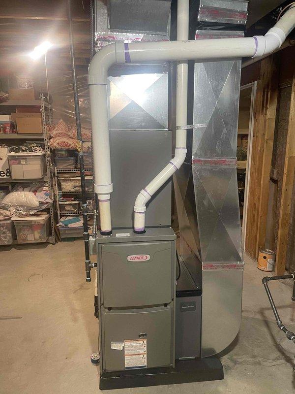 Completed full HVAC system installation in residential basement including 70,000 BTU Lennox furnace with sheet metal plenum and white PVC venting system, 2.5-ton air conditioning unit with evaporator coil configured for rear discharge, and Bradford White 50-gallon gas water heater model RG1PV50S6N. All units installed per manufacturer specifications with proper venting, gas connections, condensate drainage, and electrical reconnections. System tested and verified operational upon completion.