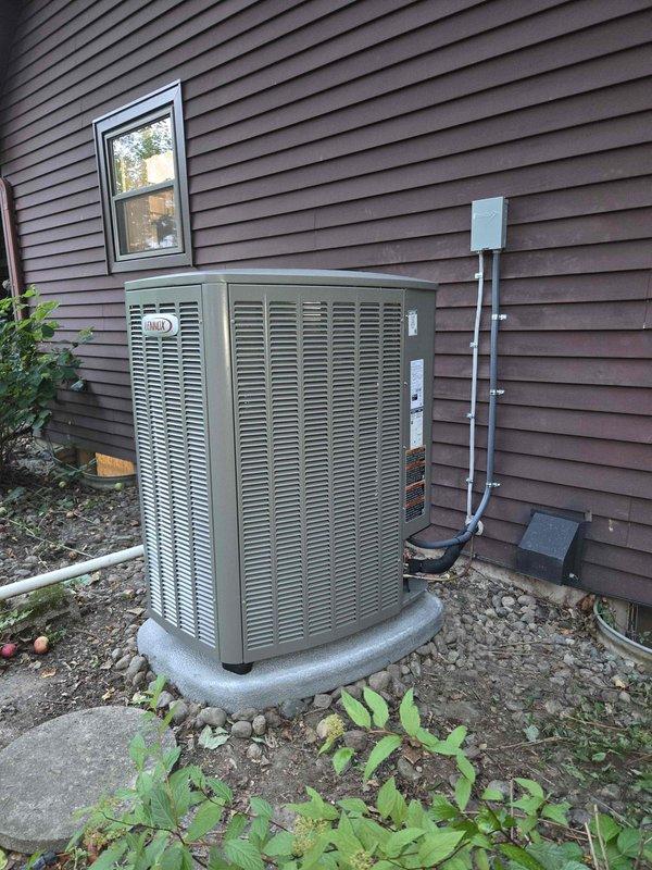 Completed full HVAC system installation including a 90,000 BTU furnace and 3-ton air conditioning unit in rear yard location. Installed Lennox outdoor condensing unit on concrete pad with proper clearances, ran refrigerant lines and electrical connections to building, mounted electrical disconnect box on exterior wall, and integrated humidifier into system. Secured all required mechanical and electrical permits prior to installation, established condensate drainage with PVC piping, and reconnected all utilities upon completion of work.