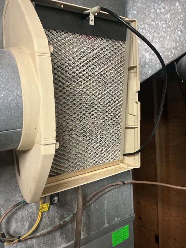 Completed annual HVAC maintenance including inspection of programmable thermostat operation, replacement of air filters, and inspection of humidifier pad which showed mineral deposit buildup. All system components were checked and found operating within normal parameters, with thermostat displaying proper temperature readings and humidity control system functioning as designed.