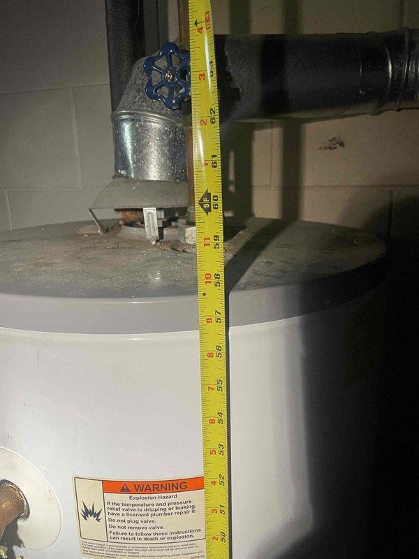 Conducted on-site assessment of leaking tanked water heater in ranch-style home to provide replacement estimate. Measured existing unit dimensions and documented current installation configuration, including pipe connections and temperature/pressure relief valve setup. Evaluated mechanical room conditions and clearances to determine appropriate replacement specifications for standard tank-type water heater system.