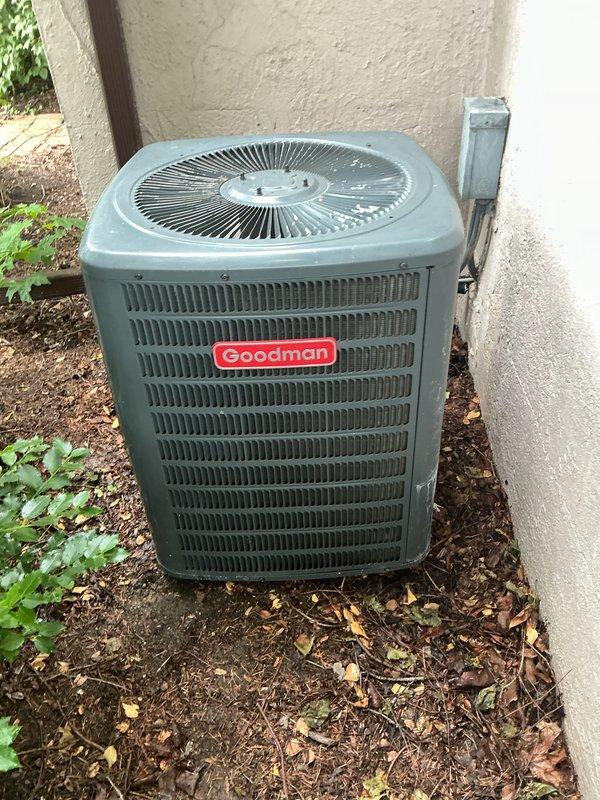 Completed annual cooling maintenance on Goodman outdoor condenser unit. Performed comprehensive system inspection including electrical connections, refrigerant levels, and component operation. Cleared vegetation and debris from around unit base and verified proper airflow through louvers and fan assembly. Confirmed electrical disconnect box secure and all safety controls functioning properly. Unit operating within normal parameters upon completion of preventative maintenance service.
