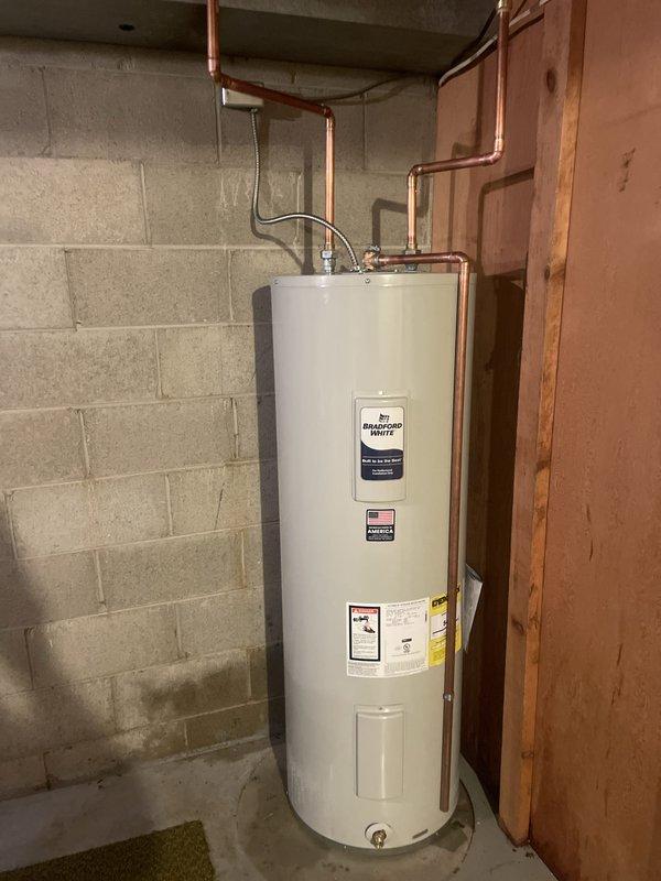 Successfully installed a 40-gallon tanked water heater in the basement utility area, positioning the unit against the concrete block wall with proper clearances. Connected copper supply lines to the top of the unit using appropriate fittings and flexible connectors, ensuring all plumbing connections were secure and code-compliant. Verified proper drainage access with floor drain proximity and confirmed all mechanical, electrical, and gas reconnections were completed per permit requirements.