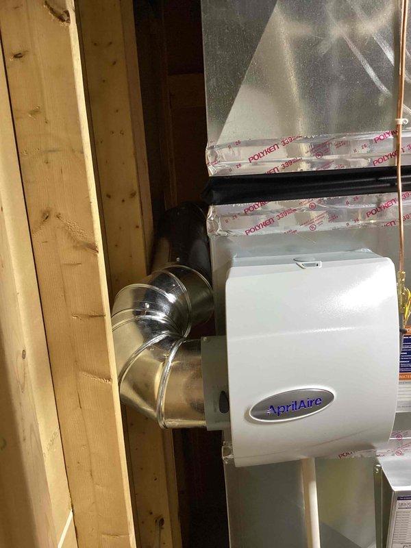 Completed full HVAC system installation including a 90,000 BTU high-efficiency furnace and 3-ton air conditioning unit with outdoor condenser located in rear yard. Installed AprilAire whole-home humidifier integrated into ductwork system with proper water supply and drain connections. Ran refrigerant lines using copper piping, installed metallic ductwork with proper insulation and sealing, and reconnected all necessary electrical and mechanical components to ensure complete system functionality.