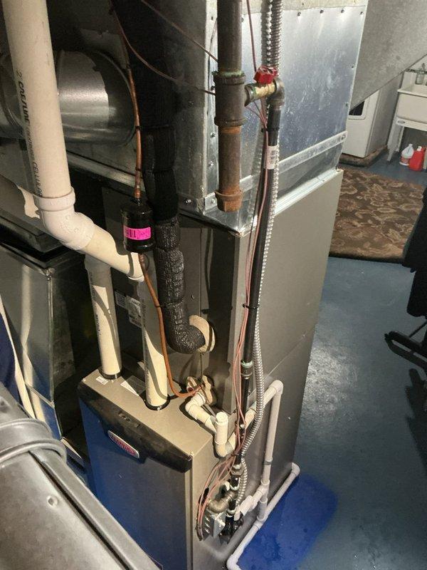 # HVAC Service Completed

Responded to service call for water leaking from furnace in basement. Upon arrival, inspected 6-year-old HVAC system and identified issue with condensate drainage system. Found significant buildup and discoloration inside PVC condensate drain line, indicating restricted flow causing water backup. Disconnected and inspected affected PVC piping section, confirming interior staining and residue accumulation preventing proper drainage. Cleared obstruction from condensate line and verified proper drainage flow. Inspected all related condensate components including trap, primary drain line, and connections to ensure system integrity. Tested system operation to confirm water is now draining properly without leakage. Unit returned to normal operating condition with condensate system functioning as designed.