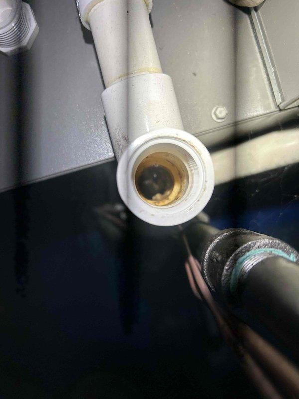# HVAC Service Completed

Responded to service call for water leaking from furnace in basement. Upon arrival, inspected 6-year-old HVAC system and identified issue with condensate drainage system. Found significant buildup and discoloration inside PVC condensate drain line, indicating restricted flow causing water backup. Disconnected and inspected affected PVC piping section, confirming interior staining and residue accumulation preventing proper drainage. Cleared obstruction from condensate line and verified proper drainage flow. Inspected all related condensate components including trap, primary drain line, and connections to ensure system integrity. Tested system operation to confirm water is now draining properly without leakage. Unit returned to normal operating condition with condensate system functioning as designed.