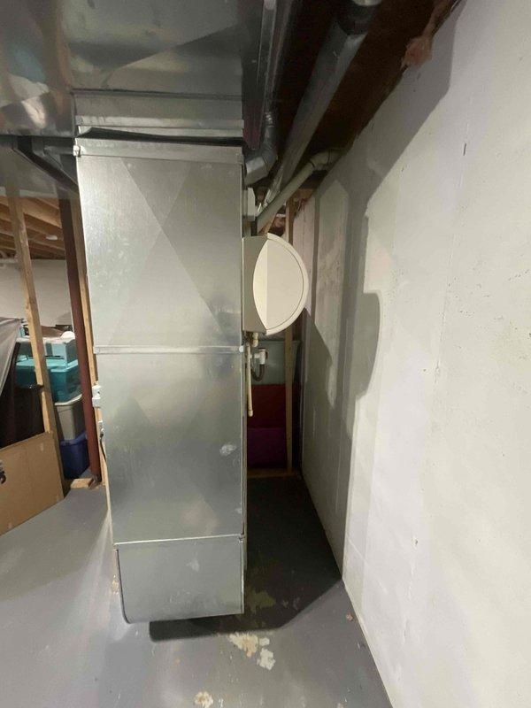 Completed on-site evaluation of 25-year-old residential HVAC system for full replacement estimate. Inspected existing furnace unit in basement utility area, noting current PVC venting configuration, ductwork connections, and overall system layout. Documented existing equipment specifications, air distribution infrastructure, and installation environment to provide accurate replacement recommendations for both heating and cooling components scheduled for fall installation.