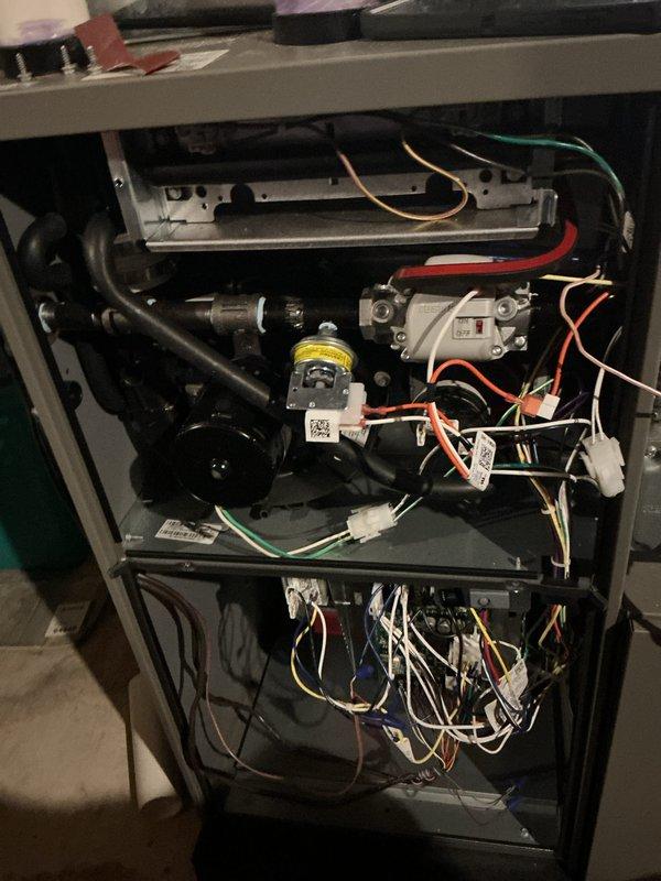Completed annual HVAC maintenance inspection on gas furnace system. Removed access panels to inspect all internal components including burner assembly, blower motor, capacitor, gas valve, and electrical connections. Verified proper operation of all mechanical and electrical systems, checked wiring harnesses and connections for secure fit and signs of wear, and inspected heat exchanger chamber. All components found to be in satisfactory working condition with normal operational wear. System tested and returned to service.