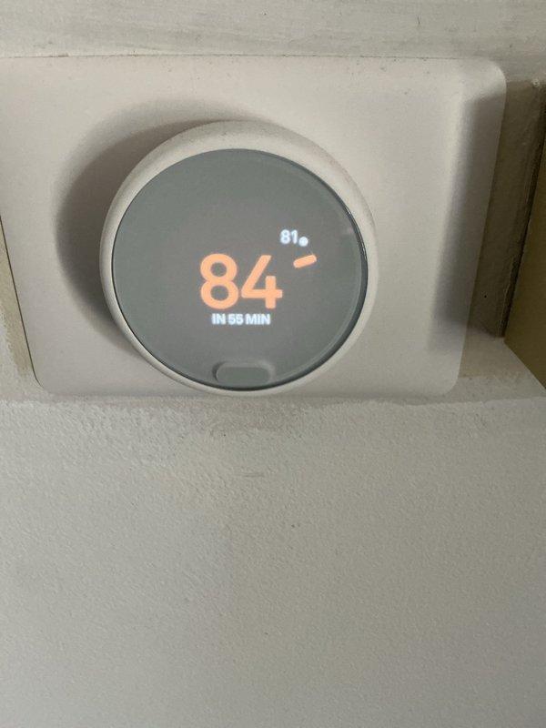 Completed annual heating and cooling maintenance on air handling unit. Inspected and documented heavily soiled air filter showing significant dust and debris accumulation throughout mesh surface, indicating extended service interval. Filter condition compromising airflow efficiency and system performance. Verified thermostat operation displaying 81°F current temperature with setpoint of 84°F and scheduled temperature change in 55 minutes. Performed standard preventive maintenance procedures including visual inspection of unit components, ductwork connections, and control systems to ensure proper operation for upcoming heating season.