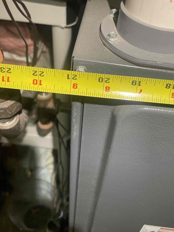 Provided replacement estimate for 30-year-old air conditioning unit located in basement with non-functional fan motor. Assessed existing equipment dimensions and configuration in utility space alongside natural gas furnace, documented current system layout including ductwork and plumbing routing for replacement planning.