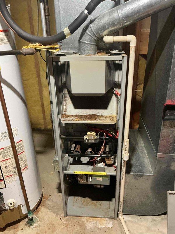 Responded to no cooling call on a 35-year-old air conditioning system that was completely non-operational with no fan activity. Upon arrival, verified thermostat settings and found unit unresponsive to calls for cooling. Performed diagnostic evaluation of outdoor condensing unit and indoor air handler components. Inspected electrical connections, capacitor, contactor, and control board for signs of failure. Given the advanced age of the equipment and complete system failure, provided customer with assessment of repair versus replacement options. Customer elected to proceed with consultation on new system installation rather than invest in repairs for aging equipment. Documented existing system configuration including furnace and air handler setup in basement mechanical room for future replacement specifications.