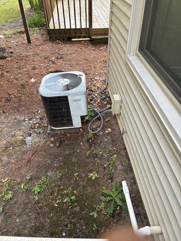 Responded to no-cooling complaint on 35-year-old residential air conditioning system with non-operational outdoor condenser unit. Upon inspection, determined that the age and condition of the equipment warranted replacement evaluation rather than repair. Documented existing installation showing weathered condenser positioned on deteriorated pad with accumulated debris, aging electrical connections, and PVC condensate lines. Provided comprehensive estimate for complete system replacement due to equipment exceeding expected service life and complete system failure.