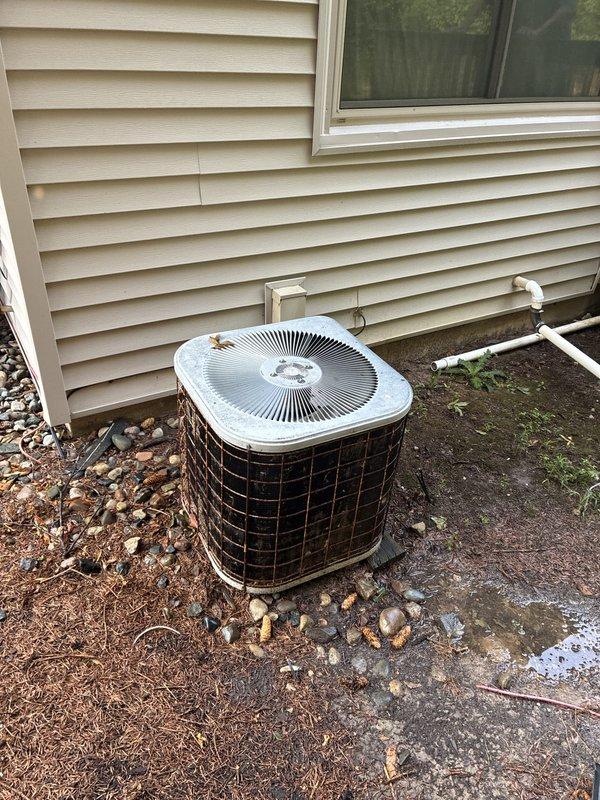 Responded to no-cooling complaint on 35-year-old residential air conditioning system with non-operational outdoor condenser unit. Upon inspection, determined that the age and condition of the equipment warranted replacement evaluation rather than repair. Documented existing installation showing weathered condenser positioned on deteriorated pad with accumulated debris, aging electrical connections, and PVC condensate lines. Provided comprehensive estimate for complete system replacement due to equipment exceeding expected service life and complete system failure.