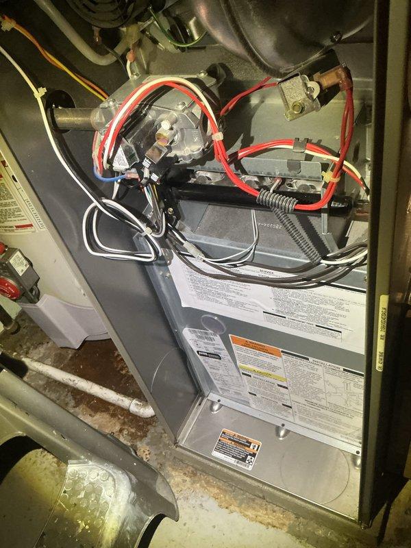 Completed routine HVAC maintenance including AC tune-up and furnace inspection. Inspected air filter condition, finding clean mesh filter properly installed in housing. Verified all electrical connections, wiring, and ductwork at furnace unit. Checked gas line connections, blower motor assembly, and ventilation components. All systems operating within normal parameters with no issues identified. Equipment ready for continued service.