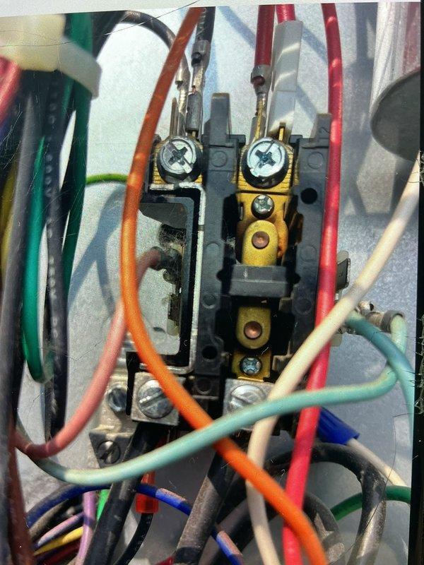 Responded to service call for rooftop HVAC system at indoor storage facility reporting improper operation. Inspected Distinctions brand central air conditioning unit and electrical connections at terminal block, verifying all wire terminations and power supply integrity. System was found operational with ability to cool; documented equipment condition with photos for facility records.