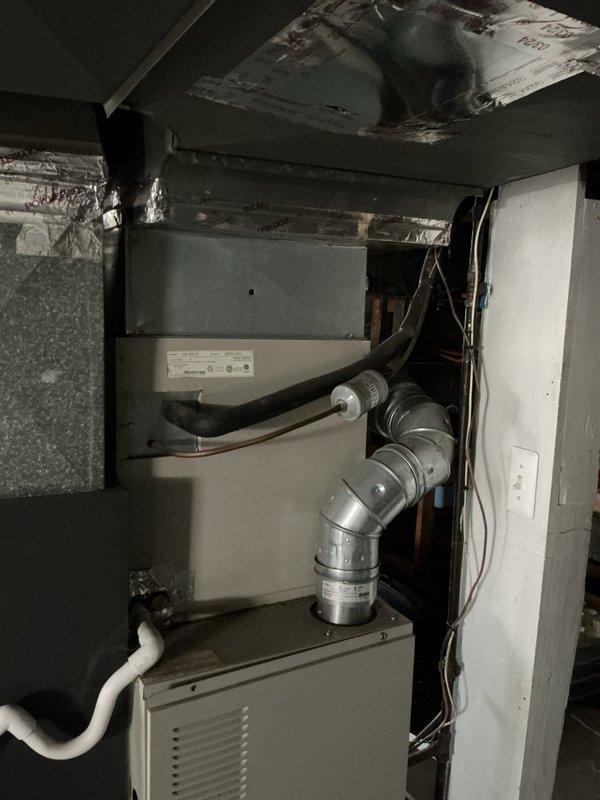 Completed comprehensive A/C tune-up on 1-2 year old system located in basement mechanical room. Performed standard preventive maintenance including inspection of air handler unit, verification of proper ductwork connections and sealing, evaluation of flexible metallic duct installations, and assessment of PVC condensate drain lines. All components found operating within normal parameters with secure duct connections and proper airflow confirmed throughout the system.