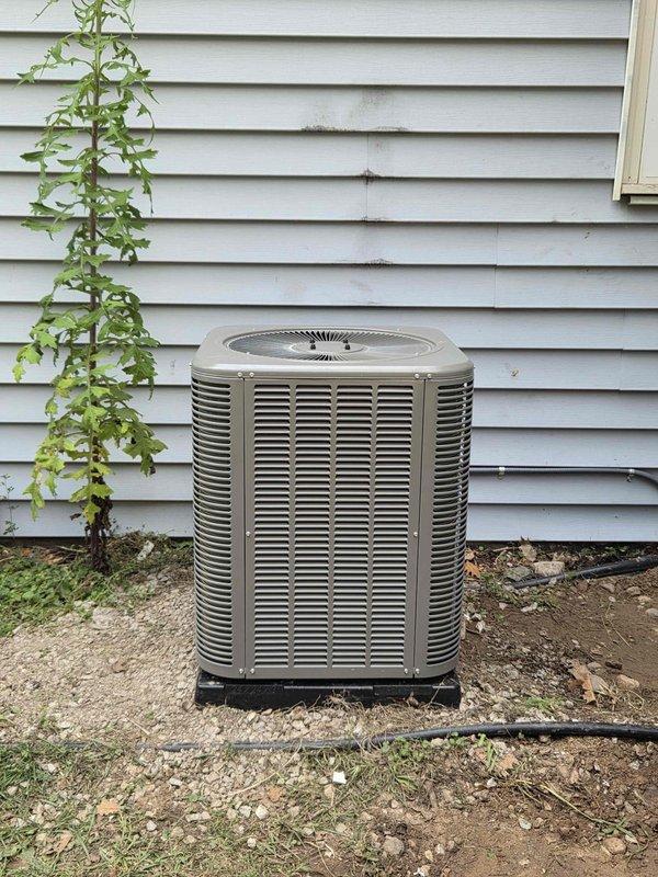 Completed installation of 2-ton Lennox air conditioning condenser unit and evaporator coil at residential property. Unit positioned on pad against rear exterior wall with proper clearances maintained, refrigerant lines connected and insulated, electrical disconnect installed, and all connections tested for leaks. System commissioned, charged to manufacturer specifications, and verified operational with proper airflow and temperature differential across coil.