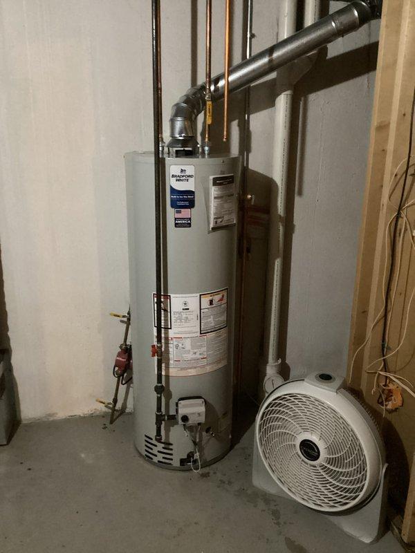 Installed a 40-gallon natural draft water heater in basement utility room, completing all mechanical connections including copper supply piping and PVC venting system. Permit was obtained prior to installation, and all work was performed to code specifications with proper reconnection of existing plumbing infrastructure.