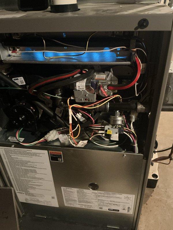Completed comprehensive ComfortGuard Maintenance Package on four-year-old forced air furnace and air conditioning system. Performed complete AC tune-up including refrigerant level verification, condenser coil cleaning, and electrical connection inspection. Conducted thorough furnace inspection with access panel removal to examine gas valves, ignition assembly, blower motor, inducer fan assembly, and control board connections. Verified all wire harnesses and electrical connections were secure throughout both systems. Inspected heat exchanger components, burner assembly, and flame sensor. Tested system controls and thermostat operation for both heating and cooling modes. Cleaned blower compartment and replaced air filter. All components found operating within manufacturer specifications with no issues identified. Both heating and cooling systems tested successfully and left in proper working condition.