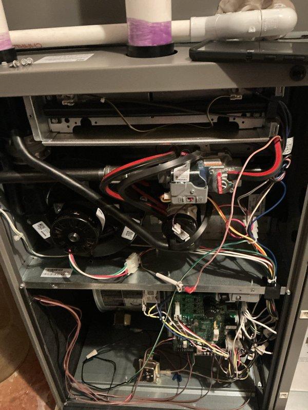 Performed comprehensive ComfortGuard Maintenance on central air conditioning system. Conducted complete AC tune-up including inspection of evaporator coil, air handler components, blower motor assembly, and control board connections. Verified all electrical connections, tested system operation, and documented equipment condition with photographs. System found operating properly with no deficiencies noted. All components including humidifier pad, ductwork connections, and condensate drainage inspected and confirmed in good working order.