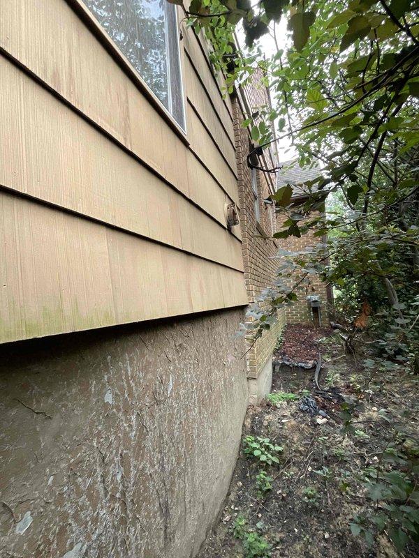 Conducted estimate for removal and replacement of 40-year-old gas-powered wall heater unit. Inspected existing installation mounted on exterior wall with venting through lap siding, documented current configuration and access conditions. Assessed narrow clearance area between structures with overgrown vegetation that will require consideration during removal and replacement process.