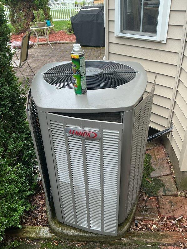 Completed routine maintenance tune-up on 6-year-old Lennox central air conditioning system. Performed comprehensive inspection of outdoor condenser unit, noting moderate dirt accumulation and biological growth on exterior surfaces and coil fins. Applied coil cleaner treatment to condenser coils to restore heat transfer efficiency, cleaned condenser fins, verified proper system operation, and confirmed unit is functioning within normal parameters with no mechanical issues identified.
