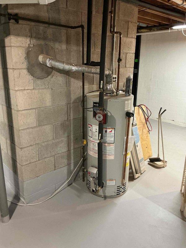 Responded to water leak complaint at basement HVAC system. Upon arrival, found approximately two gallons of water pooled on basement floor near 33-year-old York evaporator coil cabinet with visible moisture on surrounding components. Inspected evaporator coil cabinet, drain pan, and condensate drainage system. Identified clogged condensate drain line as source of overflow. Cleared blockage from drain line, verified proper drainage flow, and cleaned drain pan. Tested system operation to confirm heating and cooling functionality remained intact. Extracted standing water from floor and wiped down dampened areas around cabinet. System restored to normal operation with proper condensate drainage confirmed.