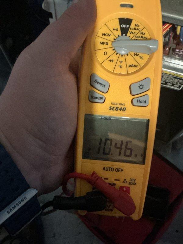 Responded to service call for water leaking from furnace during air conditioning operation. Diagnosed leak originating from 1-inch PVC condensate drain pipe at seal joint approximately halfway up where pipe transitions to downward elbow. Inspected heating system components, accessed interior compartment, and performed diagnostic testing with digital multimeter to verify system operation. Identified failed seal at PVC pipe connection as source of water intrusion. Discussed maintenance service options for furnace with property owner for consideration.