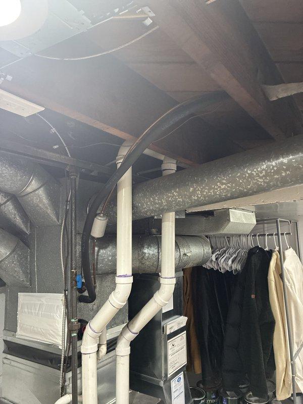 Conducted on-site evaluation of existing 15-year-old air conditioning system in residential basement utility area. Assessed current HVAC infrastructure including metallic ductwork network with reflective insulation, existing air handler cabinet, and distribution system throughout unfinished basement space. Documented equipment condition, reviewed mechanical room layout with water heater and plumbing systems, and evaluated ductwork configuration to provide comprehensive replacement estimate for new air conditioning unit to be installed within current season.