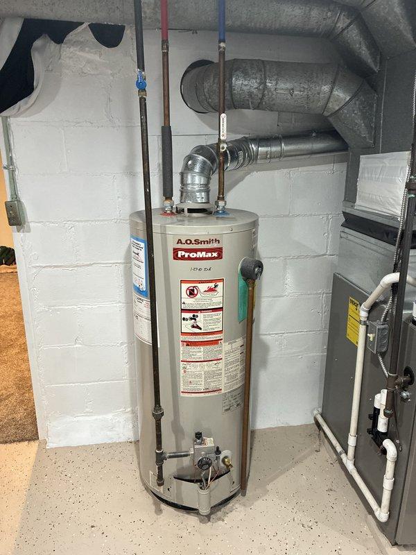 Conducted on-site evaluation of existing 15-year-old air conditioning system in residential basement utility area. Assessed current HVAC infrastructure including metallic ductwork network with reflective insulation, existing air handler cabinet, and distribution system throughout unfinished basement space. Documented equipment condition, reviewed mechanical room layout with water heater and plumbing systems, and evaluated ductwork configuration to provide comprehensive replacement estimate for new air conditioning unit to be installed within current season.