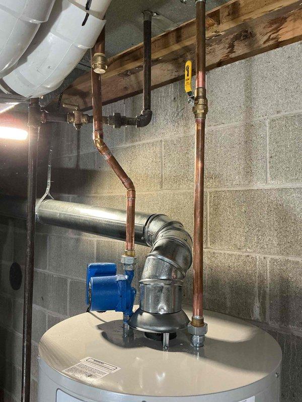 Completed installation of tanked water heater in basement utility area with reconnection of existing copper supply lines, circulation pump integration, and proper venting through galvanized ductwork. All plumbing connections were secured with appropriate fittings and shutoff valves, and the unit was tested for proper operation. Mechanical permit was requested for the installation work.