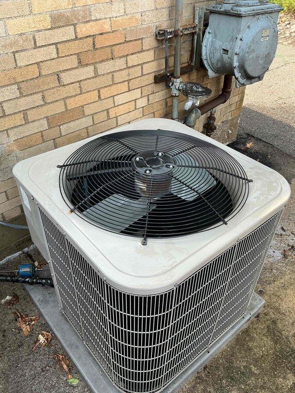 Responded to service call regarding concerns about excessive dirt accumulation on outdoor A/C units despite recent maintenance. Upon arrival, performed visual inspection of two condenser units located in exterior courtyard area. Observed normal environmental debris, surface dust, and minor weathering consistent with outdoor equipment exposure. Condenser coils showed typical dirt buildup for equipment in this setting. Documented current condition of both units with photographs showing cylindrical and square-profile condensers, fan assemblies, and associated refrigerant lines. Equipment appeared operational with no immediate maintenance concerns beyond standard cleaning requirements.