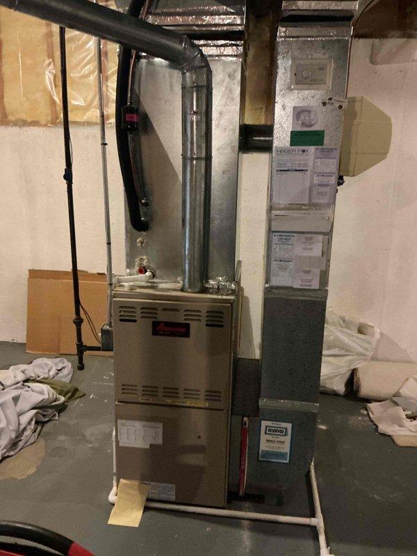 Responded to no-cool complaint on 10-year-old Carrier air conditioning system. Upon arrival, found water pooling on basement floor near furnace, traced to clogged condensate drain line from evaporator coil. System was still operating but had not received maintenance in three years. Cleared condensate blockage, restored proper drainage, and cleaned up standing water. Inspected indoor evaporator coil and outdoor condenser unit—both showed signs of neglect with debris accumulation. Performed overdue preventive maintenance including coil cleaning, filter replacement, and refrigerant pressure check. System restored to proper cooling operation with no further leaks observed.