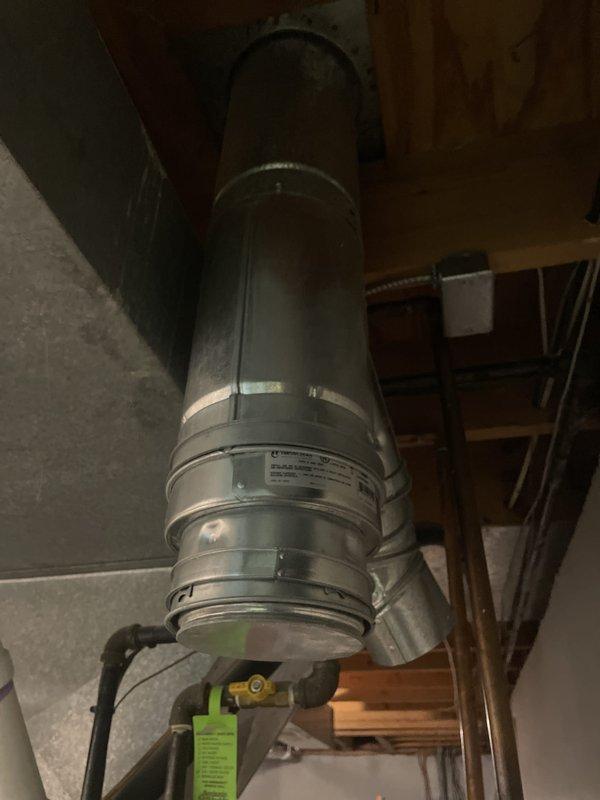 Successfully installed a new 40-gallon tanked water heater (model RG240T6N) in the basement utility area. Removed the existing unit and connected the new water heater with proper supply and discharge piping, including installation of code-compliant temperature and pressure relief valve with discharge pipe routed to the floor drain. Installed flexible metal vent pipe from the unit to the existing chimney connection to ensure proper exhaust ventilation. Completed all water supply connections, gas line hookup, and tested the system for proper operation and leak-free performance. Verified all safety devices were functioning correctly and the unit was heating properly before finalizing the installation.