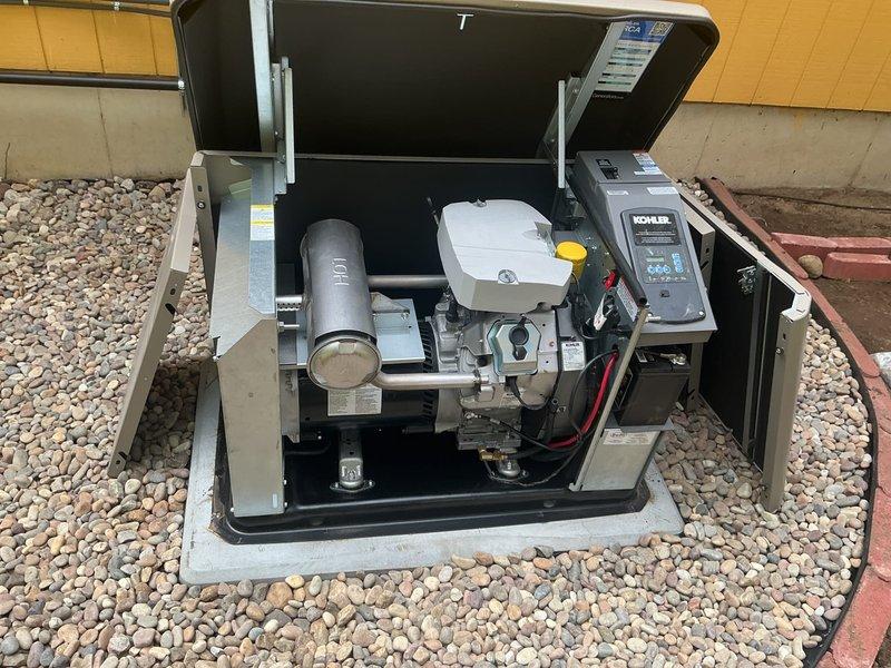 Responded to warranty callback for oil leak on recently installed Kohler 20RCA standby generator. Upon arrival, inspected generator unit with top access panel open and examined internal components including engine block, muffler assembly, coolant reservoir, and battery connections. Conducted thorough diagnostic inspection of all fluid systems, checking oil levels, connections, and potential leak points throughout the engine compartment and undercarriage mounting area. Verified proper installation of all mechanical components, fuel lines, and electrical connections. Documented generator condition with photographs showing internal components and underside mounting assembly. Unit operational at time of inspection, no active leaking observed during callback visit.