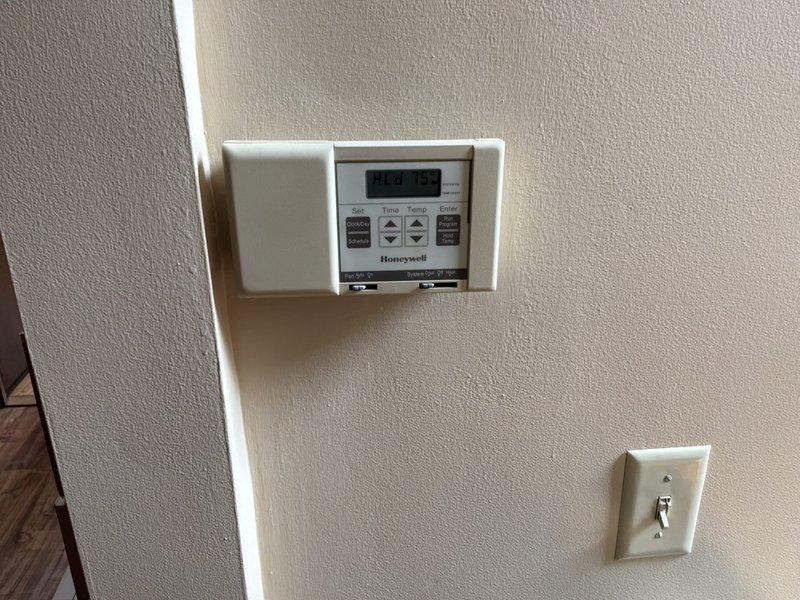 Conducted comprehensive full system estimate for 1981 two-story townhouse with basement featuring gas-fired forced air heating and central air conditioning. Evaluated existing Bryant outdoor condenser unit, indoor air handler, and complete ductwork system to address inadequate airflow to second-floor master bedroom and assess need for duct cleaning. Inspected Honeywell programmable thermostat operation, examined all refrigerant line sets, electrical connections, and disconnect box at exterior unit, and assessed overall system performance and efficiency for replacement recommendations.