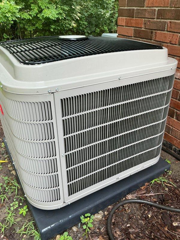 Completed annual HVAC maintenance on outdoor condensing unit. Inspected condenser coil assembly, which showed accumulation of dirt and debris between fins, and verified unit housing and protective components were intact and functioning properly. Unit operational with adequate airflow through finned coil structure.