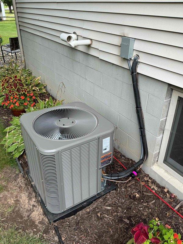 Completed full HVAC system installation including 70,000 BTU furnace, 2.5-ton air conditioning unit, and evaporator coil. Positioned outdoor condenser unit on concrete pad in left side yard with proper electrical disconnect and condensate drain line installation. Reconnected all necessary utilities and verified system operation upon completion.