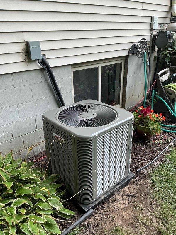 Completed full HVAC system installation including 70,000 BTU furnace, 2.5-ton air conditioning unit, and evaporator coil. Positioned outdoor condenser unit on concrete pad in left side yard with proper electrical disconnect and condensate drain line installation. Reconnected all necessary utilities and verified system operation upon completion.