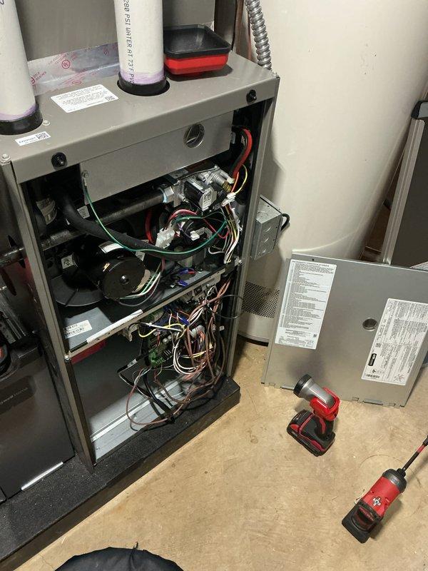 Responded to service call for newly installed 3-month-old air conditioning system unable to maintain setpoint temperature of 71°F, with house becoming excessively hot despite unit running. Performed diagnostic inspection of basement-located furnace/air handler and outdoor condenser unit. Inspected internal components including blower assembly, control boards, electrical connections, and refrigerant lines. Verified proper operation of condenser unit exterior components and checked manufacturer specifications. System covered under both parts and labor warranty. Completed troubleshooting and necessary adjustments to restore proper cooling performance and temperature regulation.
