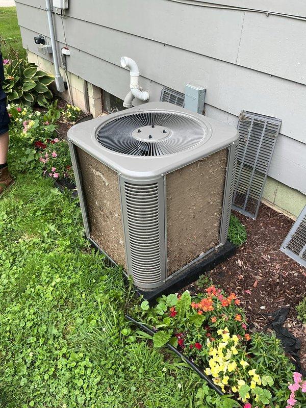 Completed comprehensive ComfortGuard Maintenance Package including AC tune-up and furnace inspection at residential property. Performed standard preventive maintenance procedures on both systems, which were operating properly with no reported issues. Documented equipment condition with photos showing outdoor condenser units with visible dirt accumulation on fins and coils requiring cleaning attention during service.