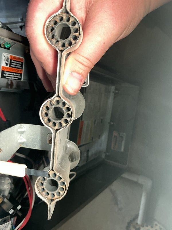 Completed annual HVAC maintenance on air handling unit, inspecting burner assembly components and drainage system. Verified proper operation of unit, checked condensate drain for blockages, and confirmed all mechanical components functioning within normal parameters.