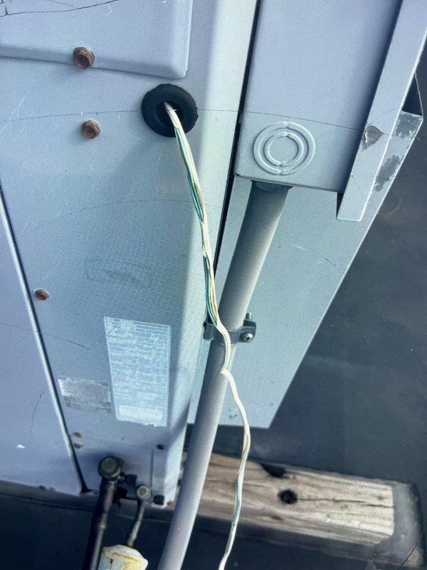 Performed diagnostic service on rooftop unit (RTU) servicing both doctor's office and retail side of commercial building. Inspected electrical connections, wiring pathways, and indoor air distribution components. Documented equipment condition including outdoor unit wiring connections through panel grommet and interior supply vent requiring cleaning due to dust accumulation.