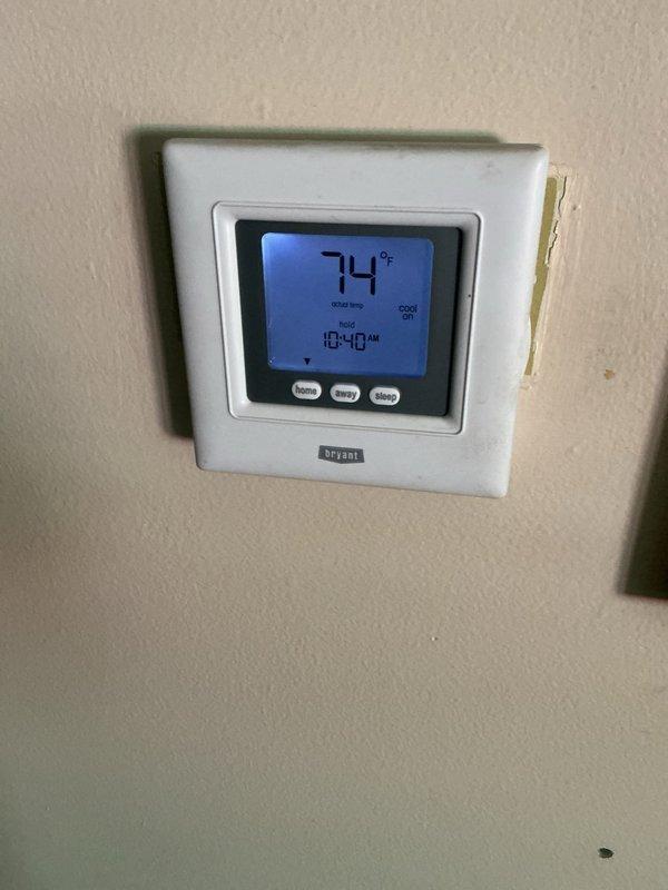Completed scheduled maintenance on Bryant split-system air conditioning unit. Performed comprehensive AHC inspection, replaced air filter and evaporator coil pad per maintenance protocol. System operating properly with thermostat displaying 74°F in cooling mode at time of service completion.