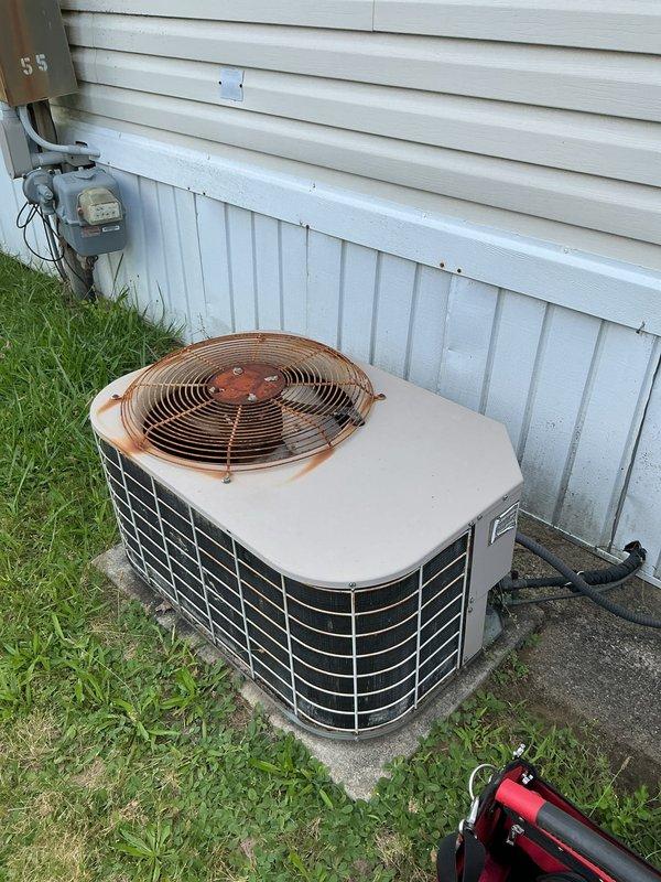 Responded to no cooling complaint on 27-year-old residential central air conditioning system with no power to outdoor unit. Upon arrival, inspected condenser unit showing significant age-related deterioration including rust staining on top panel and fan grille. Diagnosed complete system failure due to failed compressor and multiple electrical component degradation consistent with equipment age. Given the advanced age of the 1999-installed system and extent of required repairs, recommended full system replacement rather than repair due to cost-effectiveness and reliability concerns. Customer acknowledged system age and agreed that replacement would be the most practical solution. Documented equipment condition with photographs showing weathered exterior components and overall unit deterioration. System remains non-operational pending replacement decision.