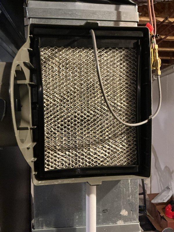 Completed annual cooling maintenance on attic-mounted air handler unit. Inspected evaporator coil access panel with expanded metal mesh filter, verified refrigerant line connections and service valves, and checked electrical control box with associated wiring. All components found in proper working order with no issues identified during routine inspection.
