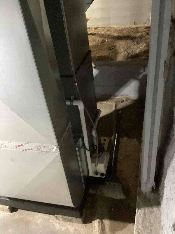 Completed full HVAC system installation including a Lennox 70,000 BTU furnace and 2.5-ton air conditioning unit with evaporator coil. Installed furnace in basement utility space with proper venting using white PVC intake and exhaust piping, mounted refrigerant lines with filter-driers and accumulator components, and established all electrical connections including disconnect switch. Positioned outdoor condensing unit in left side yard and completed refrigerant line connections between indoor and outdoor equipment. All components properly secured, labeled, and reconnected to existing ductwork and electrical systems per manufacturer specifications and mechanical permit requirements.