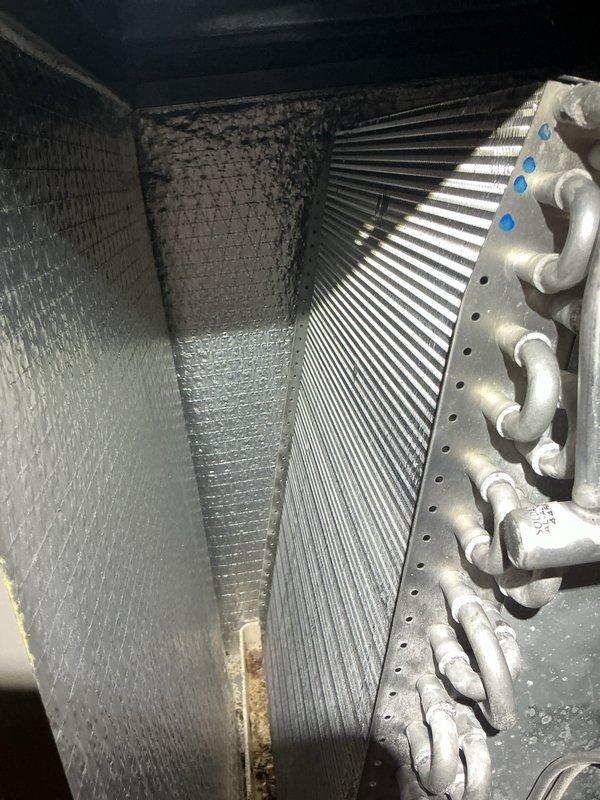 Completed annual cooling maintenance on HVAC system, including inspection of evaporator coil assembly and heat exchanger. Observed significant dust and debris accumulation on insulated interior surfaces and performed system diagnostics using digital multimeter to verify electrical components and capacitor readings. Replaced air filters as part of routine preventive maintenance to ensure optimal system performance.