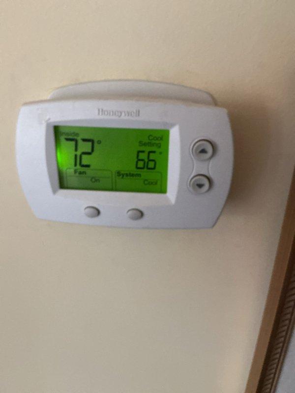 Completed annual HVAC maintenance on first of two systems, replacing air filter and humidifier pad per seasonal maintenance protocol. Verified thermostat operation showing proper heating mode function with accurate temperature display and setpoint control. System operating within normal parameters at time of service.