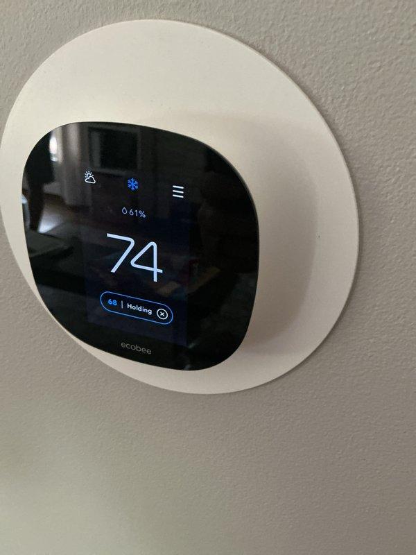 Completed comprehensive AC tune-up on 42-year-old Lennox central air conditioning system. Performed standard preventive maintenance procedures including inspection of outdoor condenser unit, verification of refrigerant levels, cleaning of condenser coils, examination of electrical connections, and testing of system operation. Verified ecobee smart thermostat functionality and confirmed proper communication between thermostat and cooling system. System operating within normal parameters with no deficiencies noted. All components functioning as designed with adequate airflow and temperature differential. Documented equipment condition with photographs showing outdoor condenser unit and indoor thermostat display reading 74 degrees with system set to hold at 68 degrees in cooling mode.